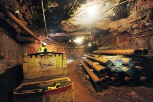 Bill Heisinger drives a train through a mine tunnel 4,850 below the surface in the Homestake Mine. The Sanford Underground Laboratory. (photo by Benjamin Brayfield, Rapid City Journal.)