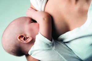 Baby feeds on MOM's breasts