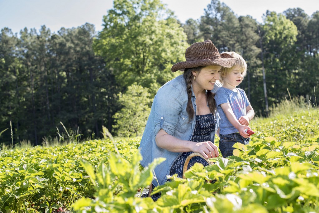 April McGreger (pictured with her son) strives to promote sustainable, small-scale agriculture and handmade preserving through her business, Farmer's Daughter. (photo by Lissa Gotwals)