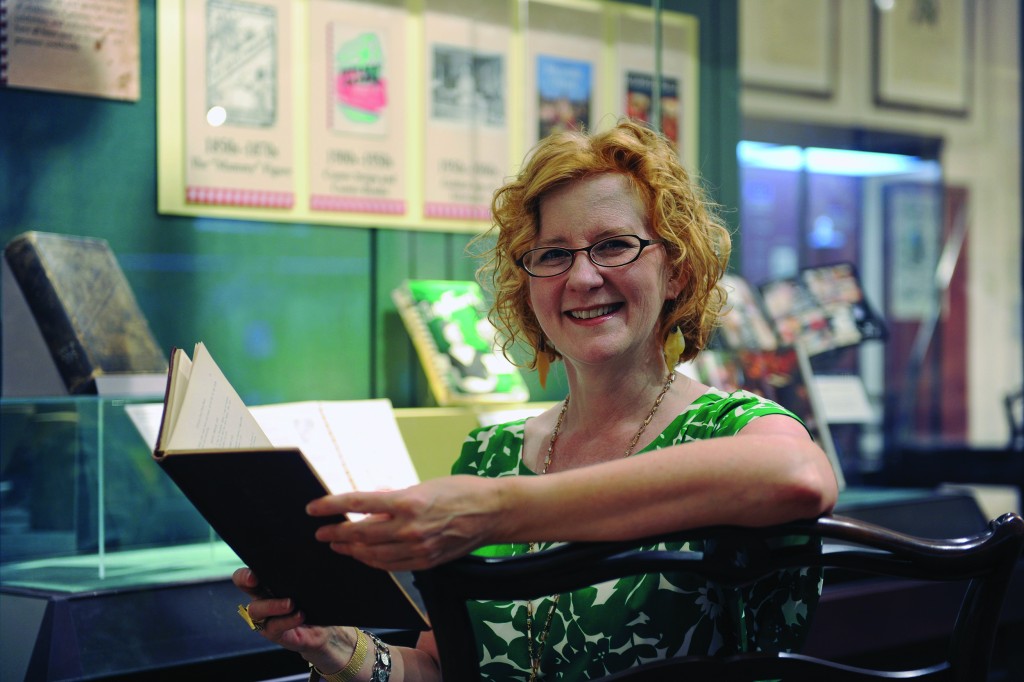 Elizabeth Engelhardt examines cookbooks in an exhibit at Wilson Library. (photo by Donn Young)