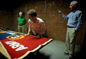 The Army Navy Efficiency Flag presented to Firestone mill. From left, former employee Bill Passmore, Ph.D. student Elijah Gaddis and Digital Innovation Lab director Bobby Allen. 