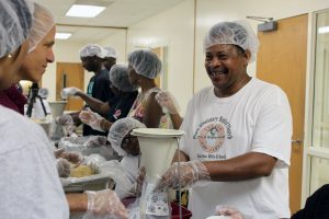 Volunteers participate in a meal packaging event at Peace Missionary Baptist Church in Durham. (photo by Beth Lawrence)