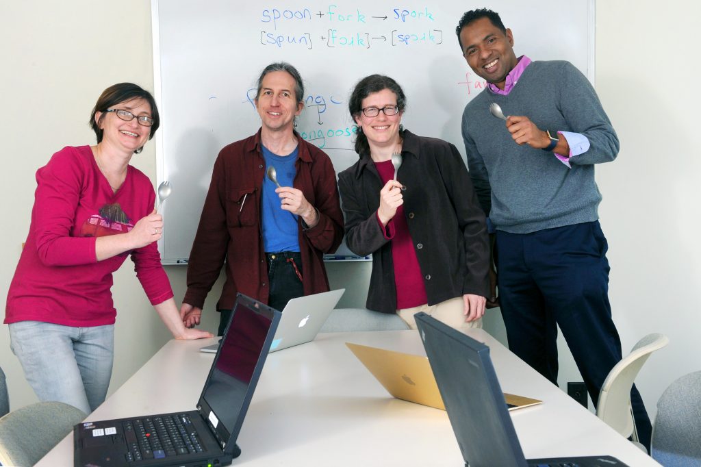 From left, linguists Katya Pertsova, Elliott Moreton and Jennifer Smith and computer scientist Fabian Monrose are exploring using lexical blends like the word “spork” to create attack-resistant passwords. They’re holding titanium sporks (both flexible and strong) as a symbol of their partnership. (photo by Donn Young)