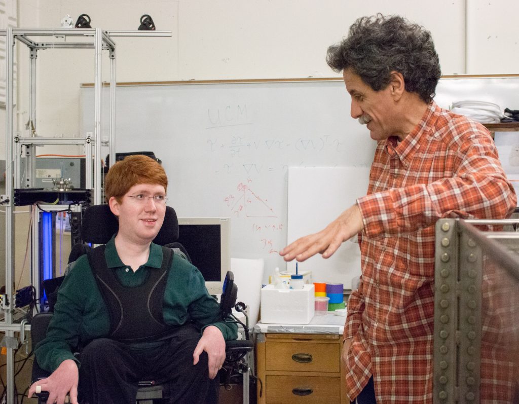 Physics graduate student Jeff Olander (above, left) discusses research with mathematician Roberto Camassa. (photo by Kristen Chavex)