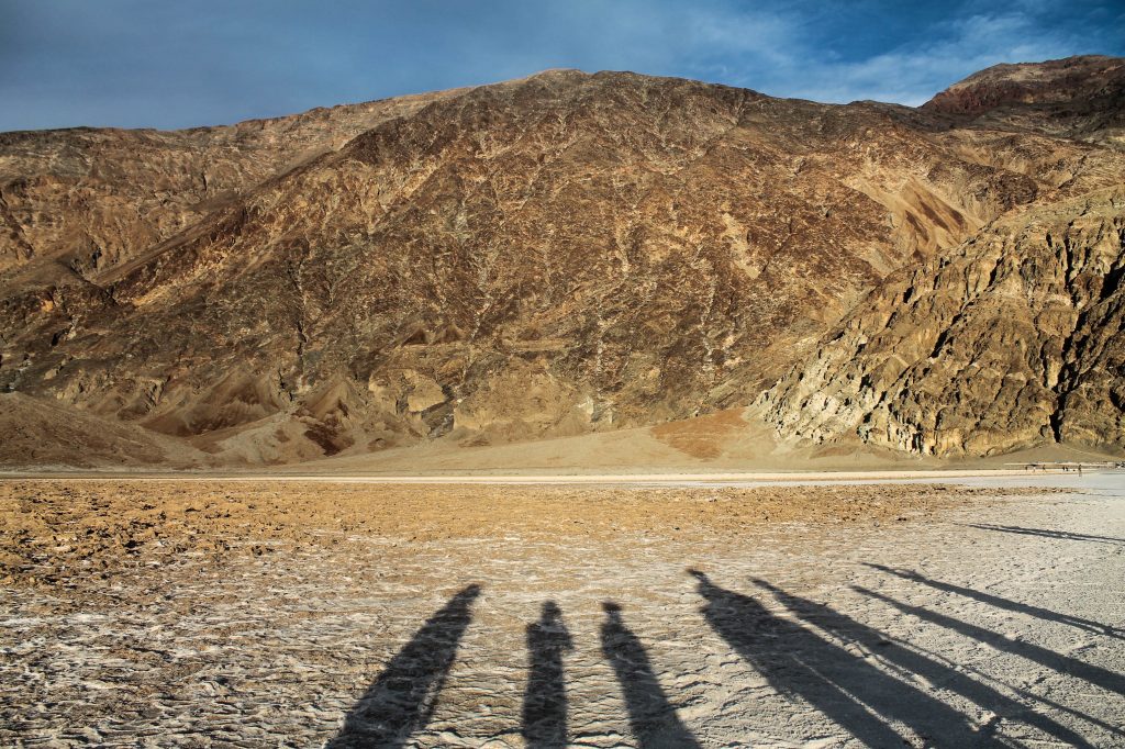 Undergraduate students in “Field Geology of Eastern California” conduct field research in Badwater, Death Valley, where long shadows form one afternoon at the foot of the Black Mountains. (photo by Jack Davidson)