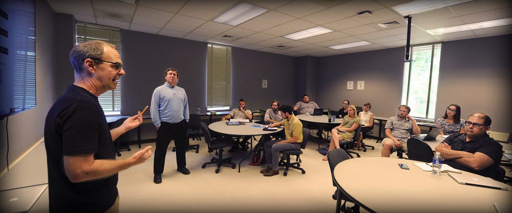 Dan Anderson, left, director of UNC’s Digital Innovation Lab, and Todd Taylor, director of the Writing Program, teach a hands-on workshop for English 105 instructors at the start of the fall semester. The session focused on how to design digital class projects. 
