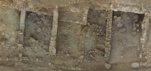 An aerial view of the storerooms of the West Building at Azoria shows deposits of storage vessels.