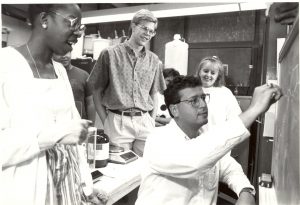 Joseph DeSimone (right) with his first doctoral student, Valerie Ashby (far left), around 1990. DeSimone is one of Carolina’s most accomplished professors and entrepreneurs. Ashby is now dean of Duke University’s Trinity College of Arts & Sciences. (photo courtesy of N.C. Collection, University Libraries)